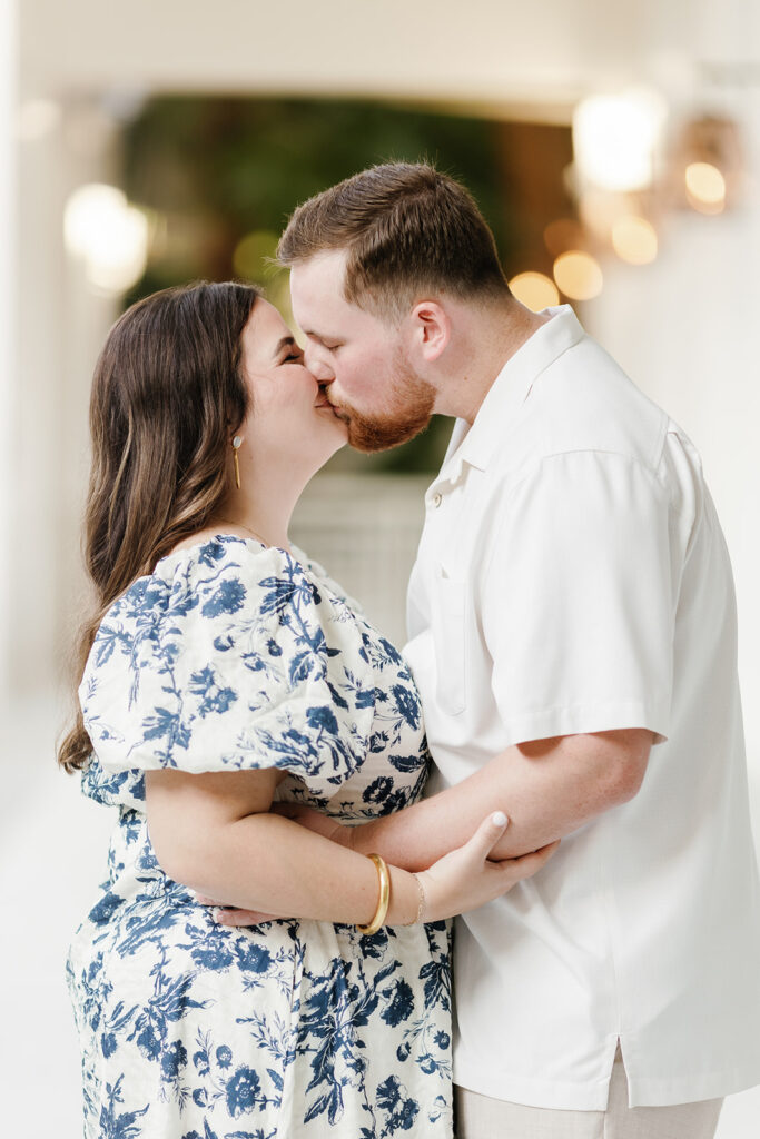 Claire and Reece share a romantic kiss in the softly lit interiors of the resort, captured by a destination wedding photographer.