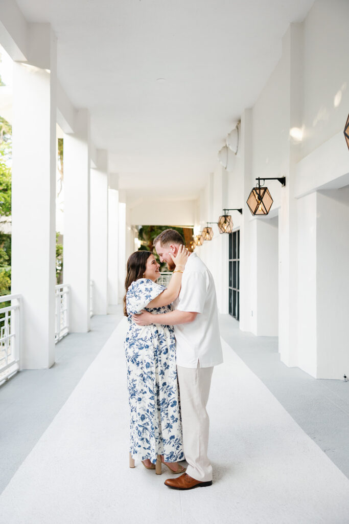 The couple stands wrapped in love beneath the classic lantern-lit walkways of the resort, beautifully framed by a destination wedding photographer.