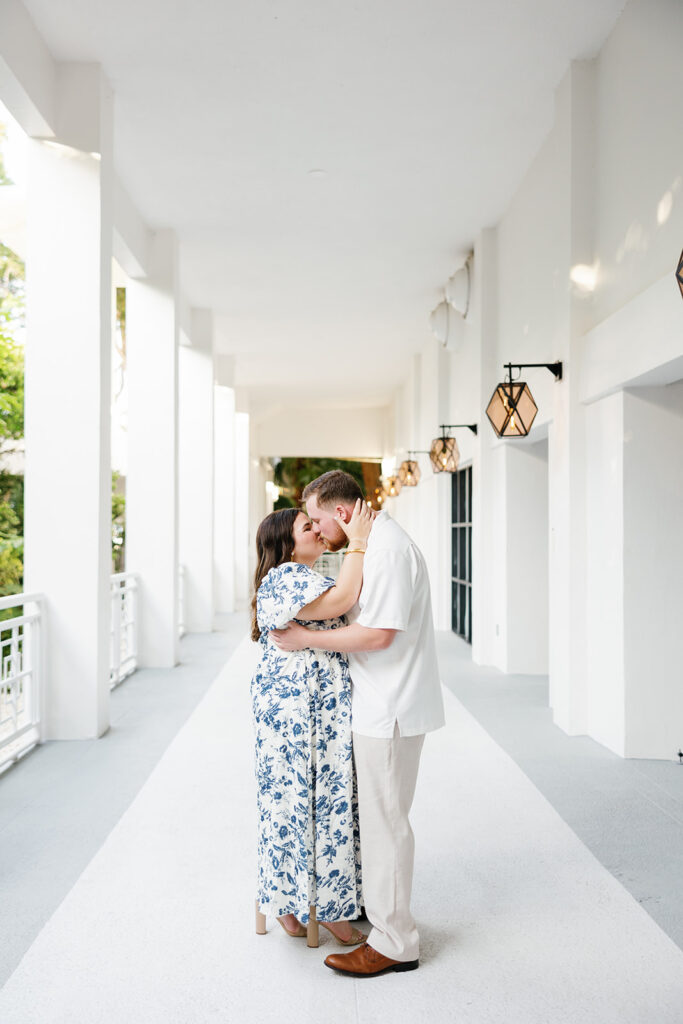 A romantic embrace in the grand white corridor of the resort, where Claire and Reece’s engagement session feels effortlessly timeless.