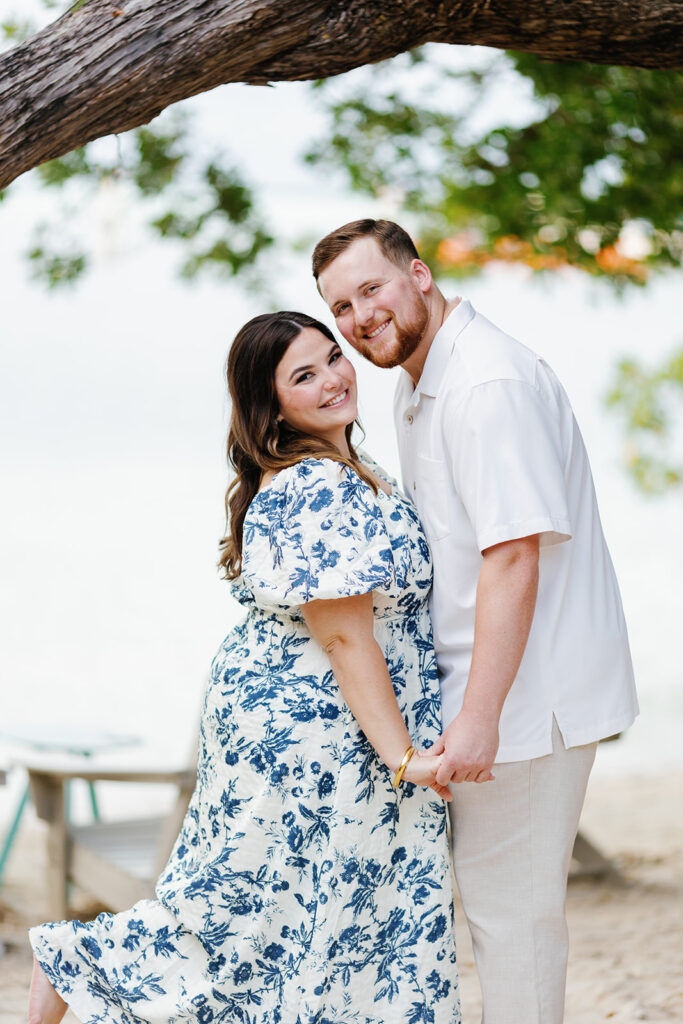 Claire and Reece hold hands and smile under the Key Largo sun during their engagement shoot, beautifully photographed by a Key Largo wedding photographer.