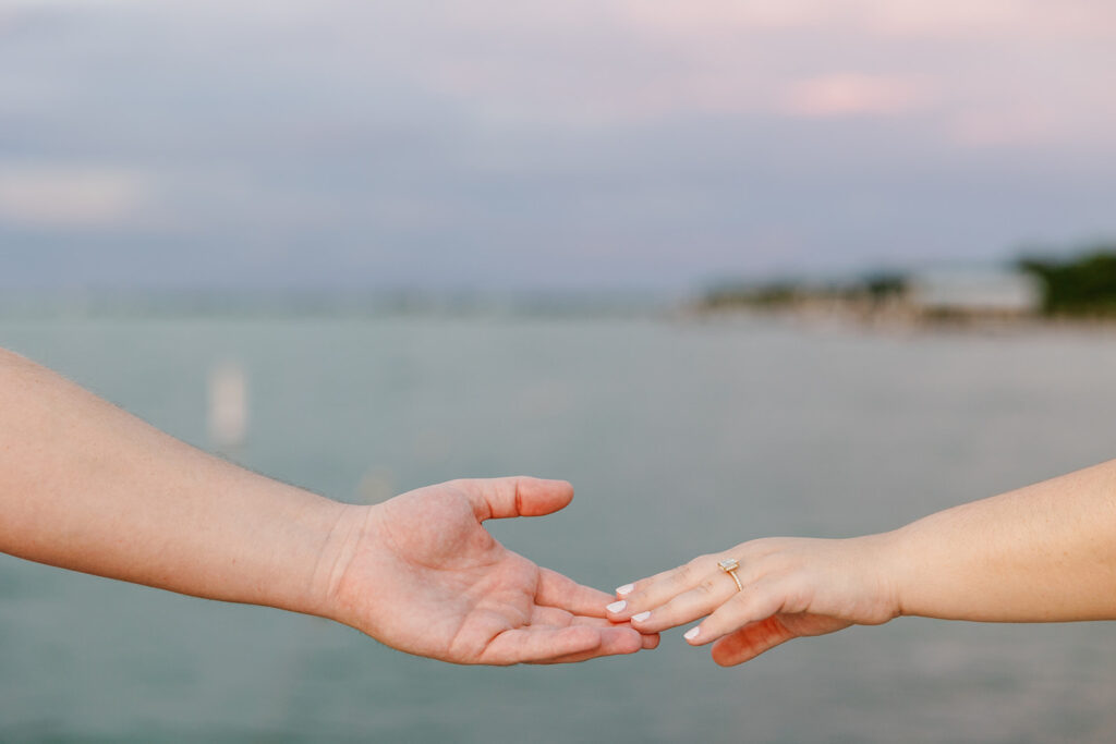 A close-up of Claire and Reece’s hands reaching for each other, her engagement ring sparkling in the golden light at their engagement session. A simple but powerful detail capturing their love.