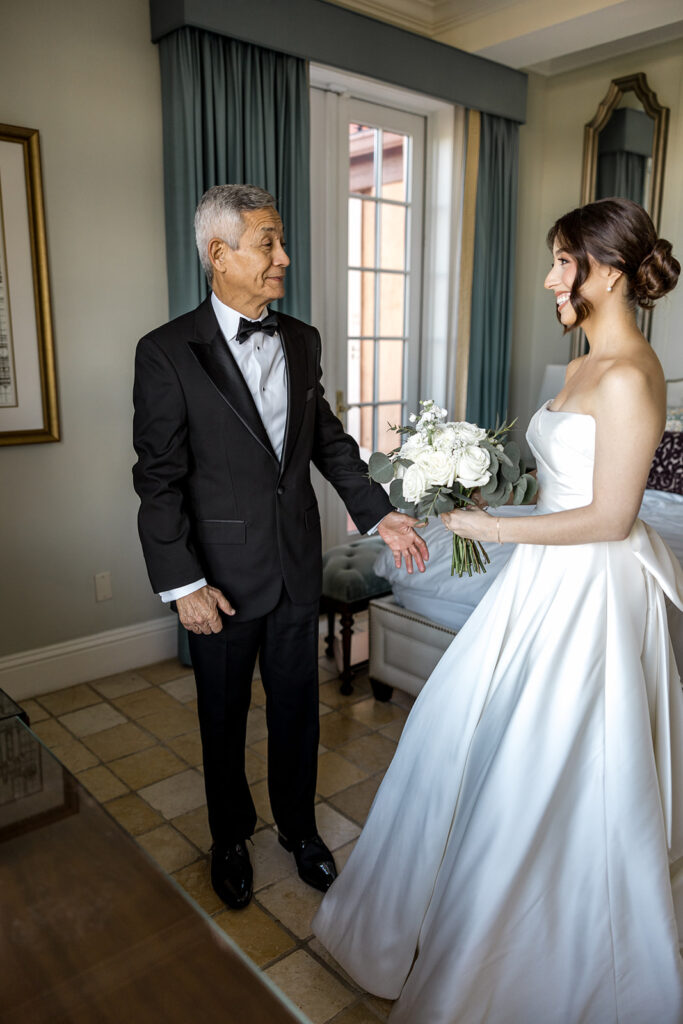 Bride Jeannie’s father smiles warmly as he sees her in her wedding gown at Biltmore Hotel Coral Gables.