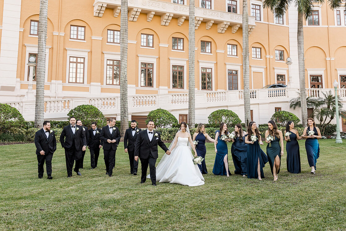 Bride and groom walking with their wedding party at Biltmore Hotel Coral Gables.