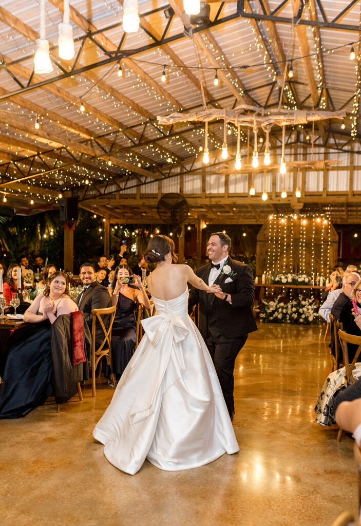 Bride and groom smiling at each other while dancing during their reception at Biltmore Hotel Coral Gables.