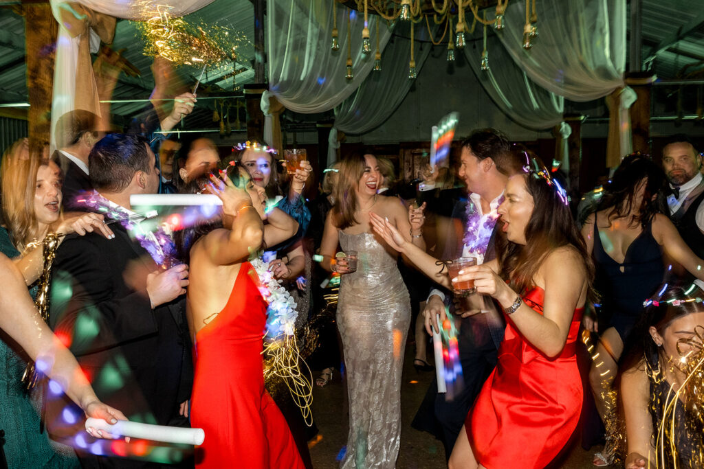 Guests dance with glow sticks and light-up accessories at Jeannie and Carlos’ wedding reception at Biltmore Hotel Coral Gables.