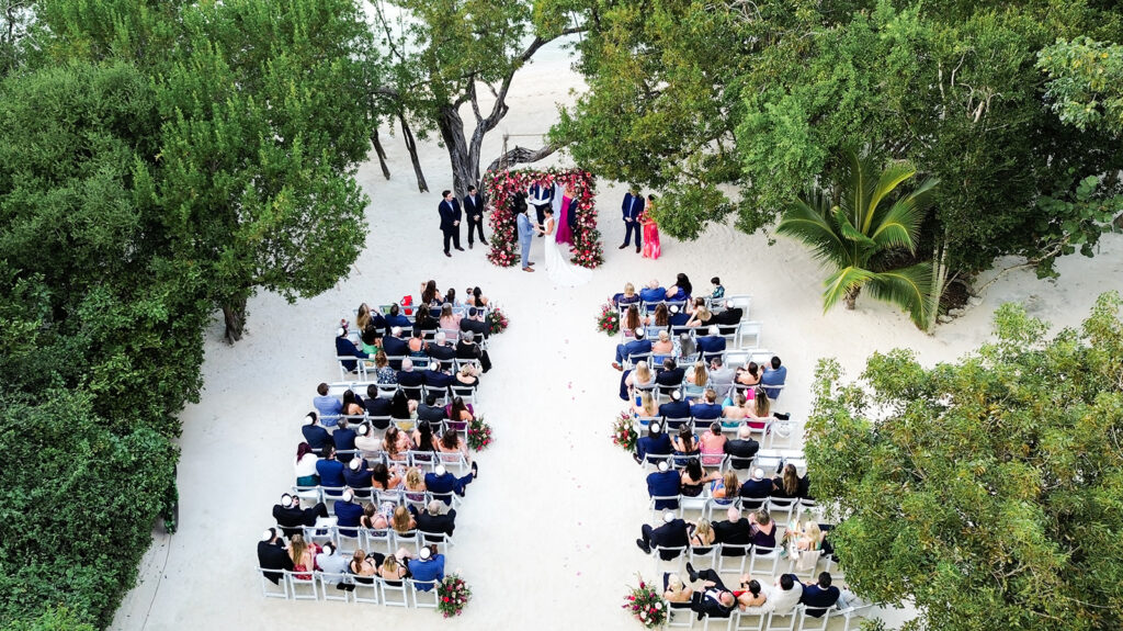 Drone shot of Rebecca & Graysen's wedding ceremony at Baker's Cay resort. Captured by Claudia Amalia.
