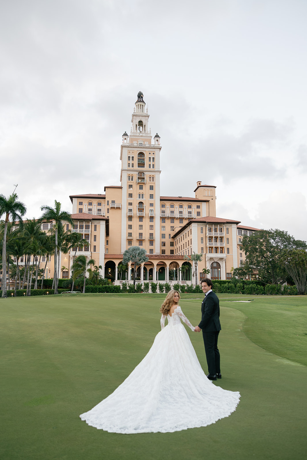 Couple posing with the Biltmore Hotel in Coral Gables as the backdrop