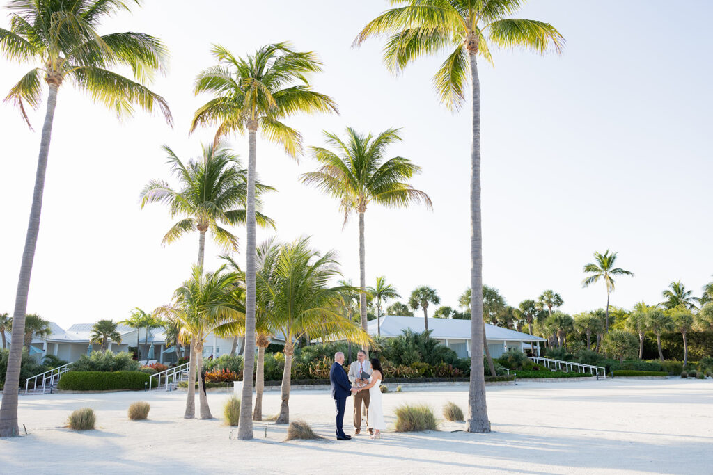 Intimate beach elopement ceremony under palm trees in the Florida Keys.
