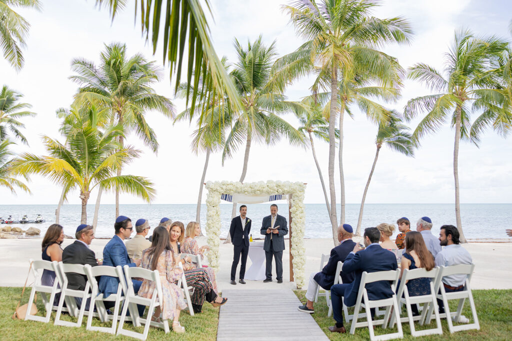 Beach wedding ceremony set up under a white arbor at a scenic Florida Keys weddings venue.