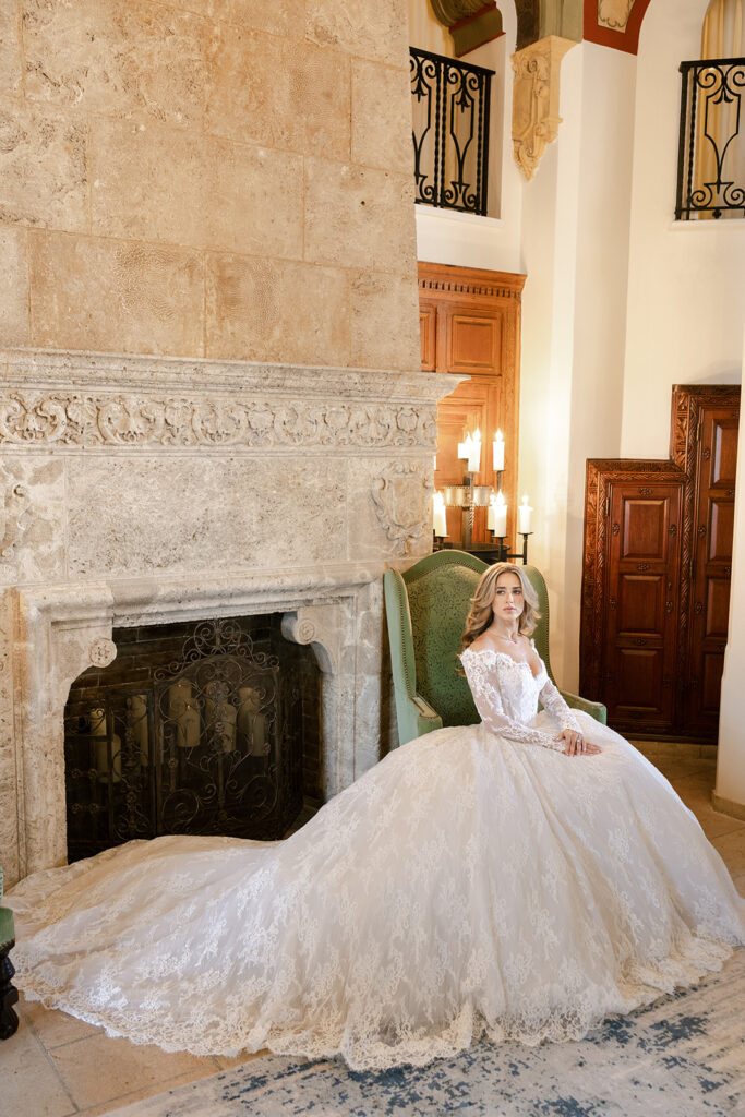 Bridal portrait in an ornate stone fireplace lounge, captured by a Florida wedding photographer.