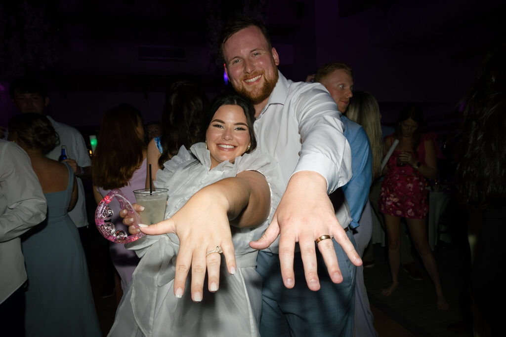 Happy couple showing rings on the dance floor during a fun Florida Keys weddings reception.