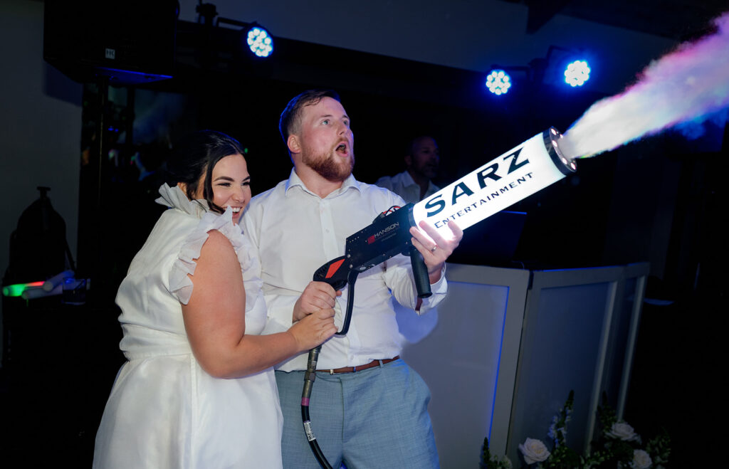 Couple celebrating with a party cannon on the dance floor at their destination Florida Keys weddings party.
