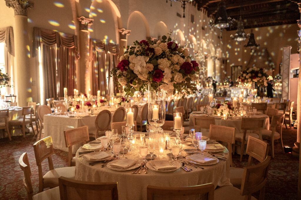 Ornate ballroom setup with floral centerpieces and mood lighting for a city wedding reception.