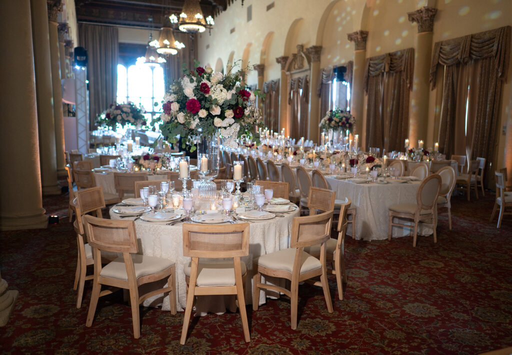 Elegant round tables and chairs setup in a luxury ballroom for a formal Miami weddings reception.