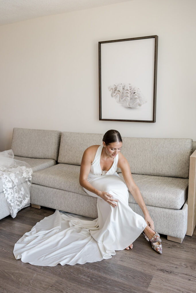 Bride putting on her wedding shoes before her destination Key Largo weddings ceremony.