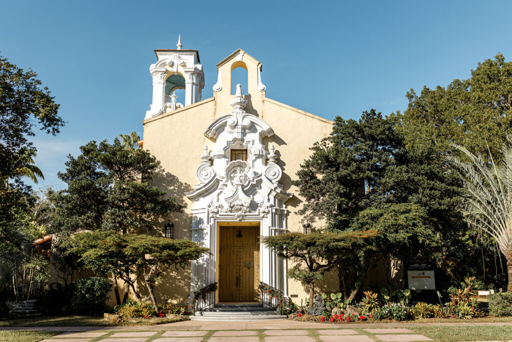 Ornate yellow exterior of a Spanish-style chapel for a South Florida city wedding ceremony.