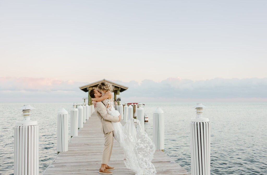 Romantic portrait of couple kissing on a dock for their Key Largo weddings session.