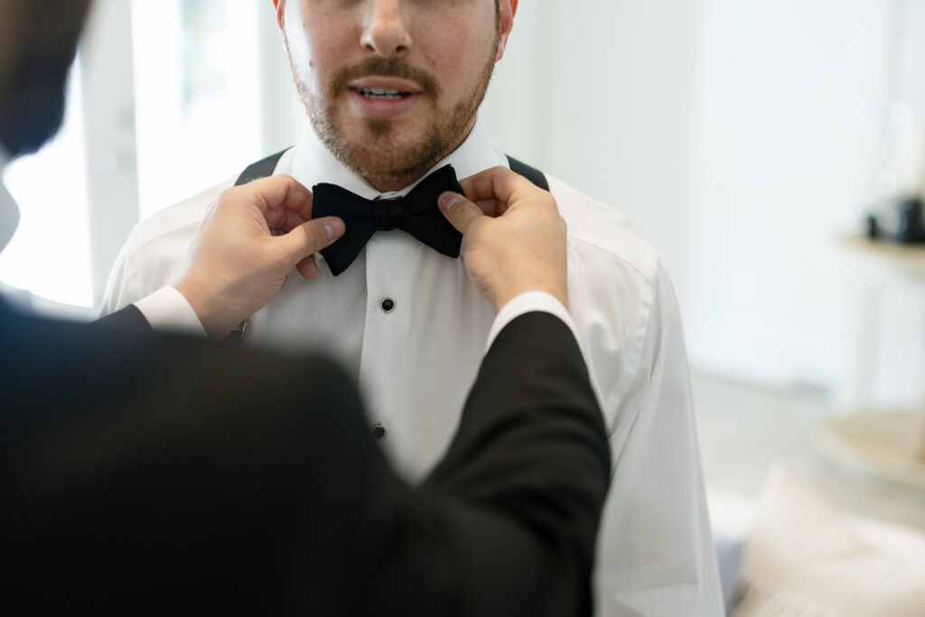 Groom with his father during wedding morning getting ready photos