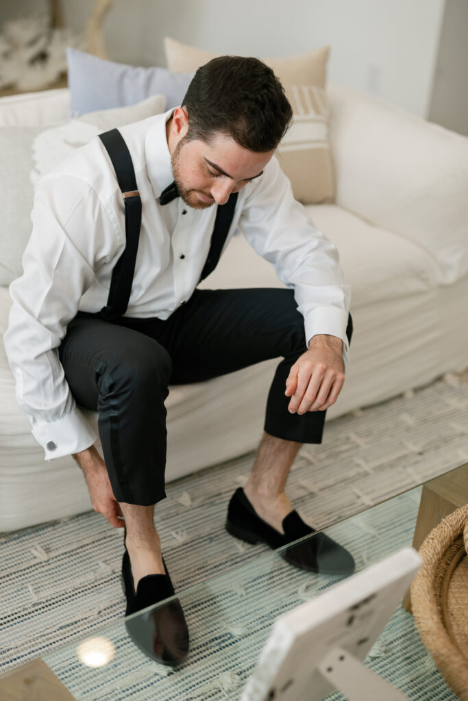 Groom during wedding morning getting ready photos
