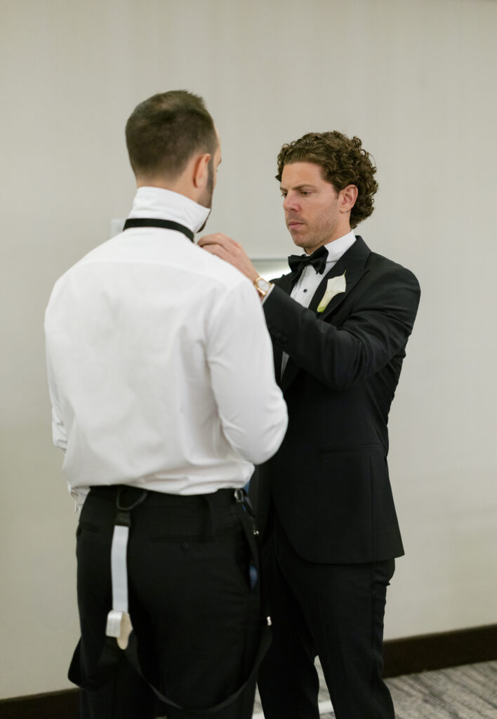 Groom with his groomsmen during wedding morning getting ready photos