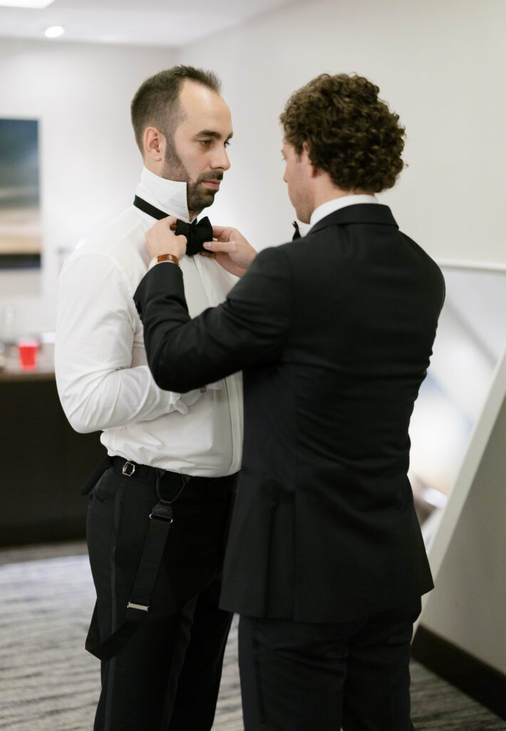 Groom with his groomsmen during wedding morning getting ready photos
