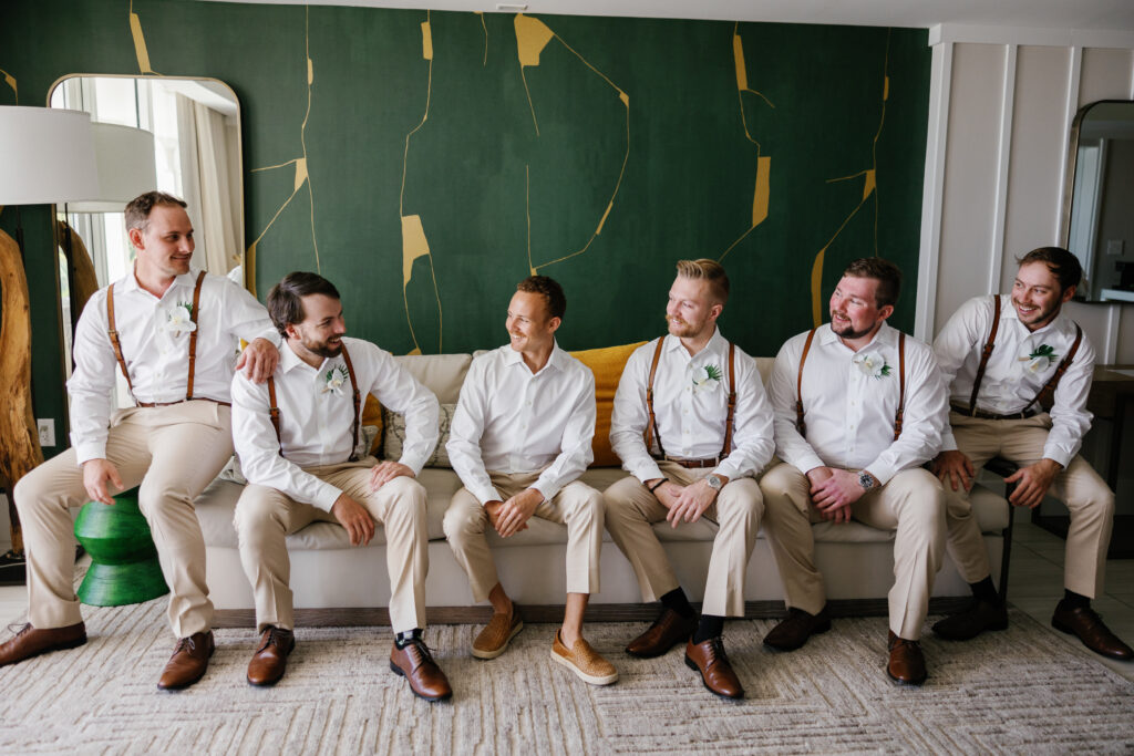 Groom with his family during wedding morning getting ready photos